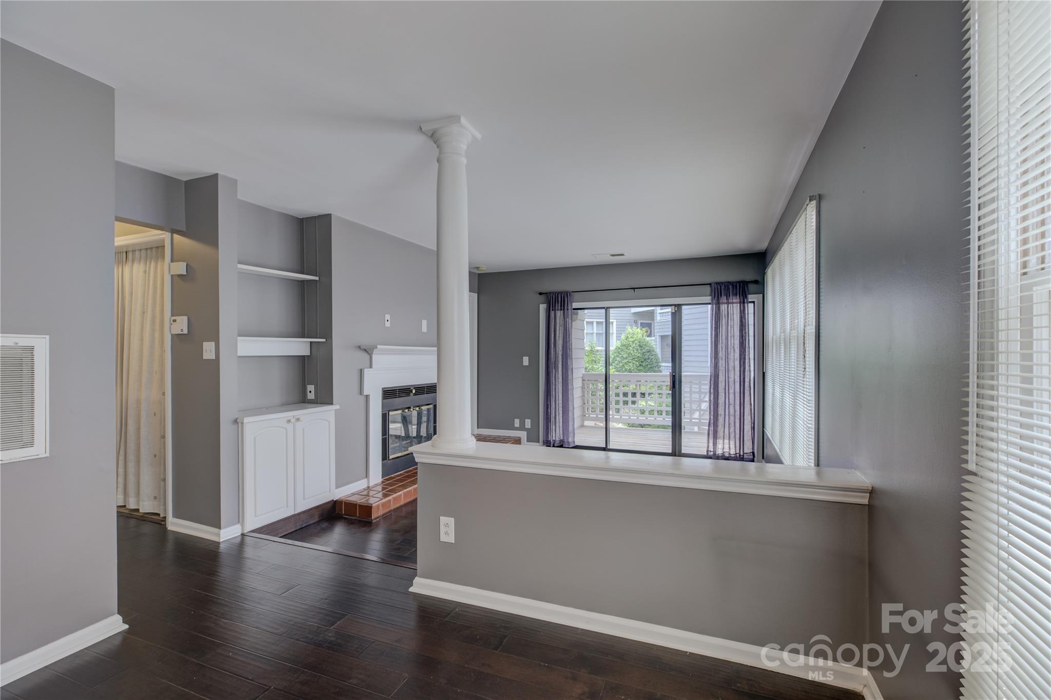 226 Queens Road, Unit 68 Charlotte, NC 28204 - Photo 10 of 40 a view of an empty room with a window and wooden floor