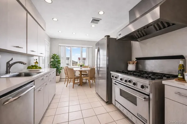 a kitchen with granite countertop a refrigerator and a sink