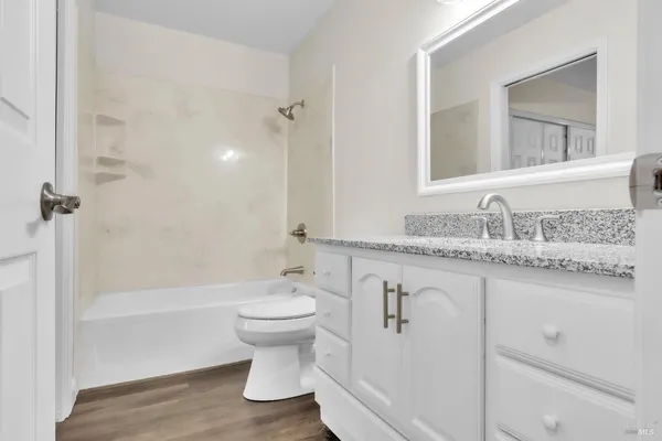 a bathroom with a sink toilet a mirror and shower