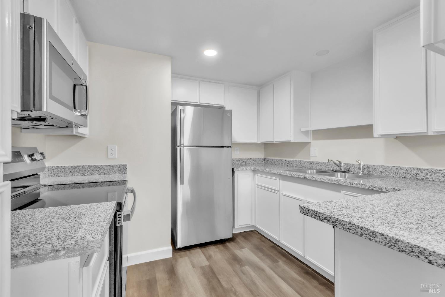 128 Del Rio Court, Unit 4 Vacaville, CA 95687 - Photo 9 of 23 a kitchen with stainless steel appliances granite countertop a refrigerator and a stove top oven