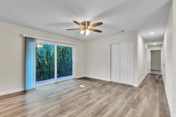 a view of a livingroom with a ceiling fan and window