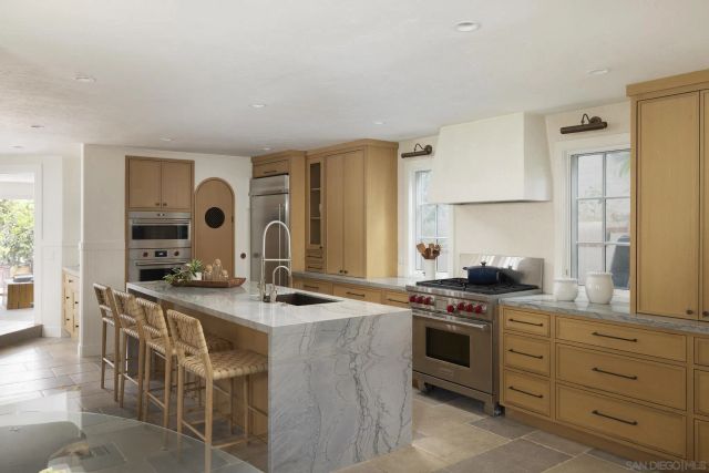 a kitchen with a stove top oven sink and cabinets