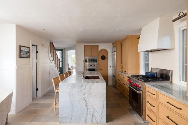 a kitchen with a refrigerator and a stove