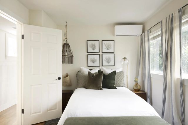 a bedroom with a bed and a window