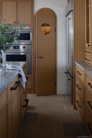 a view of kitchen area with wooden cabinets