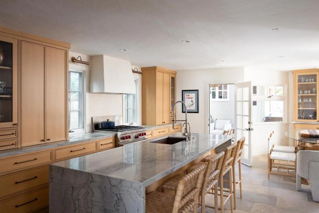 a dining hall with stainless steel appliances granite countertop a sink a stove and a refrigerator with wooden floor