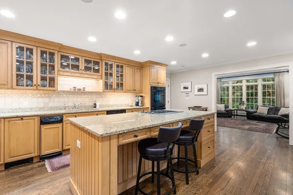 a kitchen with a table chairs sink and cabinets
