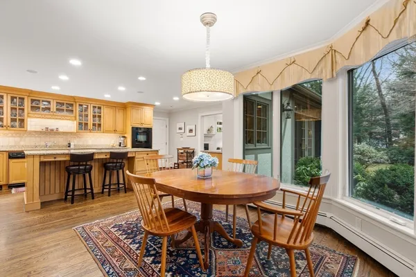 a dining room with furniture window and wooden floor