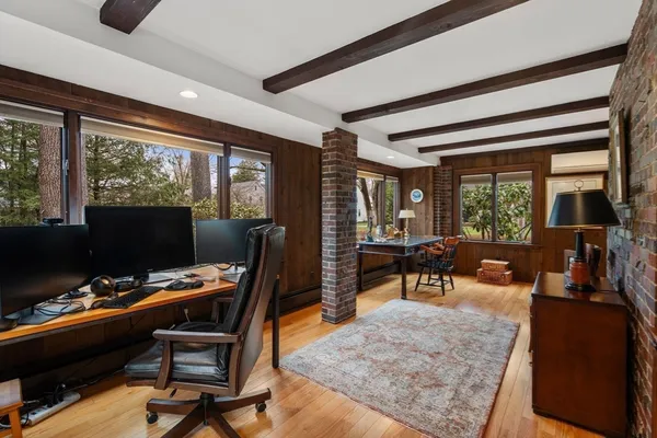 a work room with furniture and large windows