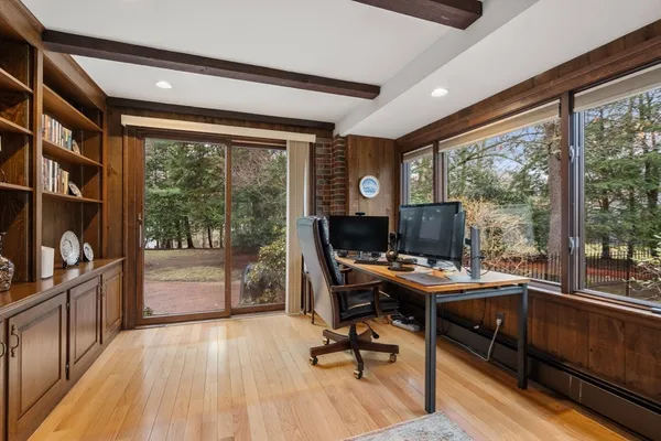 a view of a workspace with furniture and a window