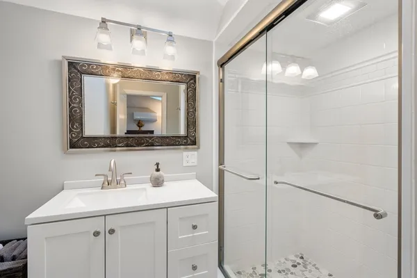 a bathroom with a sink vanity and a mirror