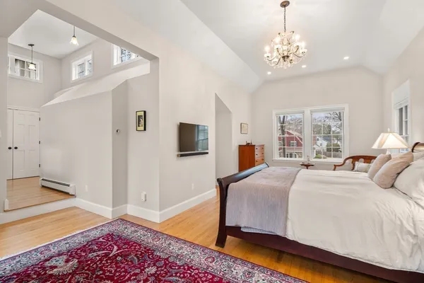 a bedroom with a bed and a chandelier