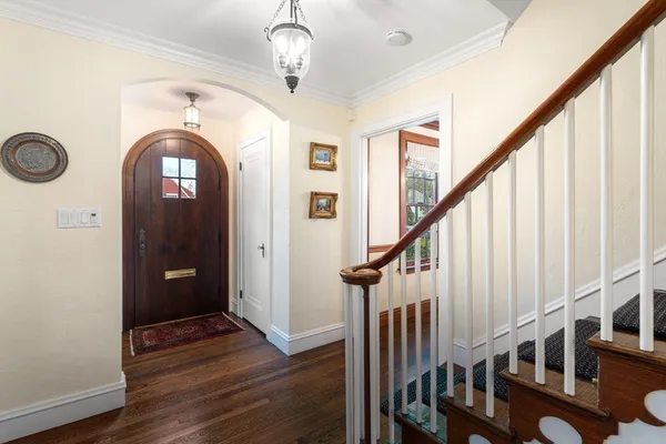 a view of entryway with wooden floor and stairs