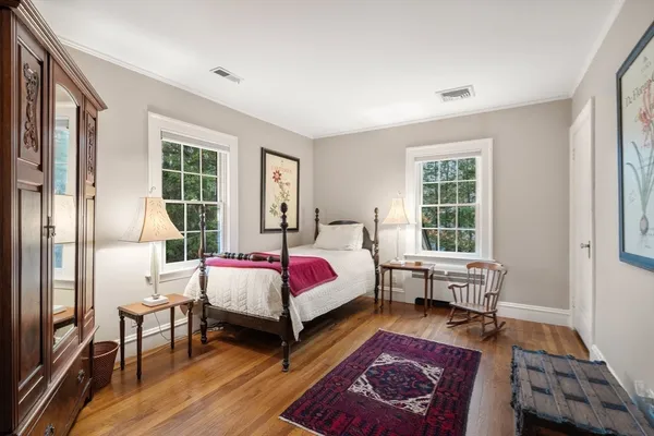 a spacious bedroom with a bed couch and a window