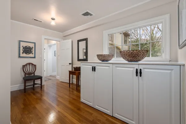 a view of hall way with furniture and window