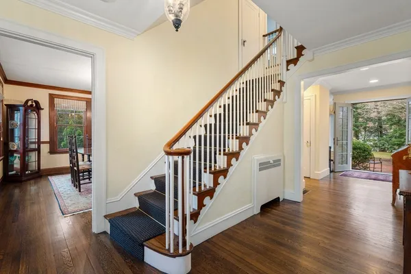 a view of staircase with wooden floor and a floor to ceiling window