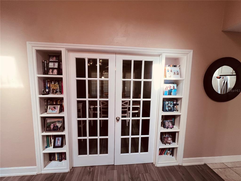 357 Tymber Run Ormond Beach, FL 32174 - Photo 13 of 32 a view of a bedroom with wooden floor and a window