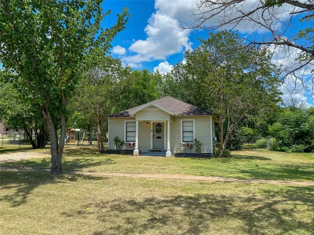 a front view of a house with a garden