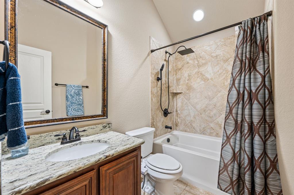 5209 Edgebrook Way Fort Worth, TX 76244 - Photo 24 of 33 a bathroom with a granite countertop sink toilet and shower
