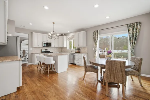 a dining room with furniture window and wooden floor