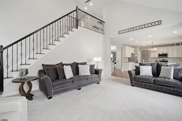 a living room with furniture and a chandelier