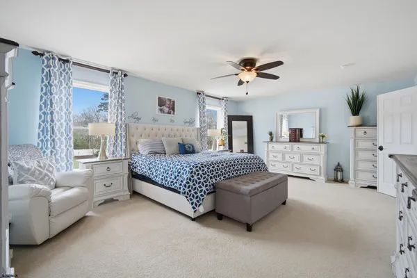 a bedroom with a bed couch and window