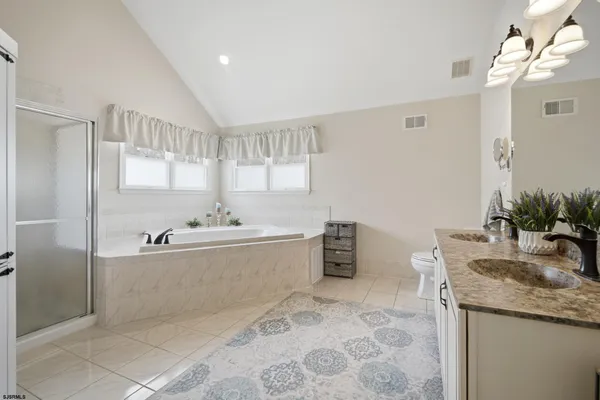 a bathroom with a tub a sink and a window