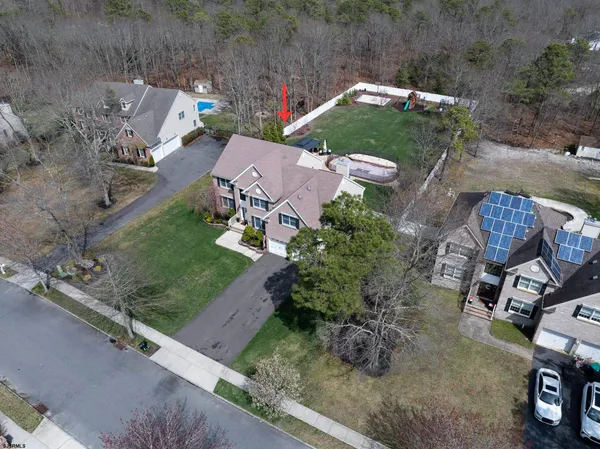 an aerial view of a house with a yard and lake view