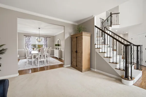 a view of a livingroom with wooden floor and furniture