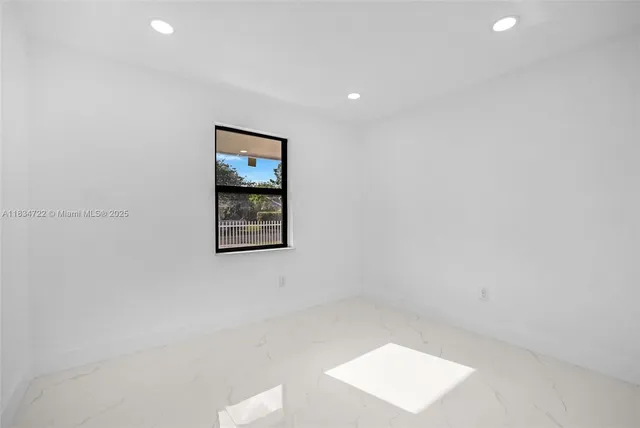 an empty room with a painting on the wall