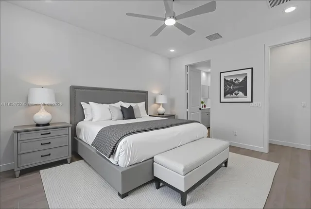 a room with a bed and a painting on the wall