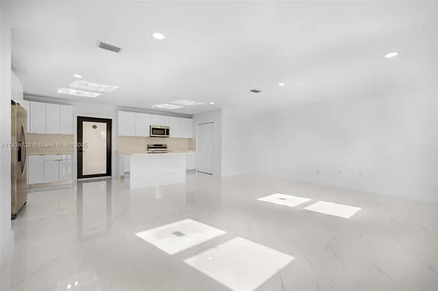 a view of a kitchen with a refrigerator