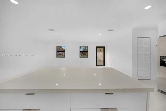 a view of a livingroom with a refrigerator