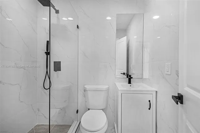 a bathroom with a toilet sink and shower