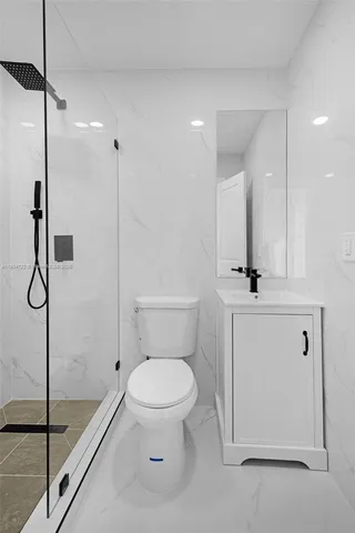 a bathroom with a toilet sink and shower