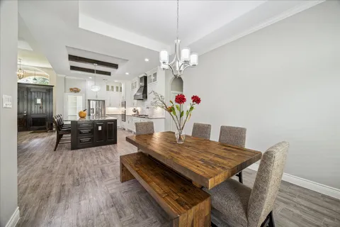 a kitchen with stainless steel appliances granite countertop a stove and a wooden floors