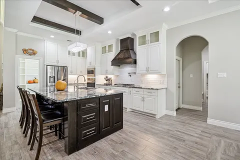 a kitchen with stove and cabinets