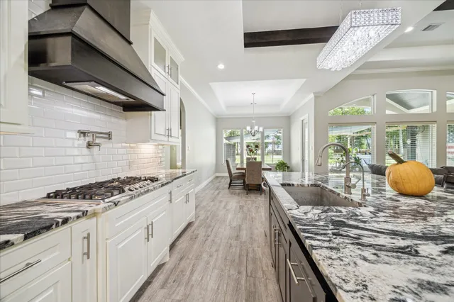a kitchen with stove and cabinets