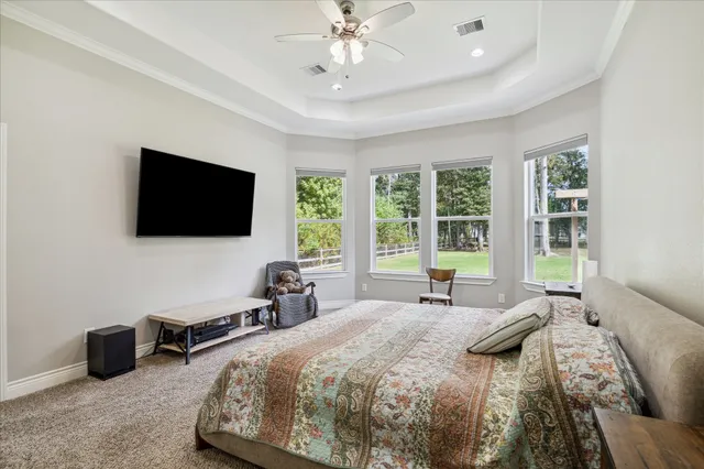 a bed room with a bed and a flat tv screen