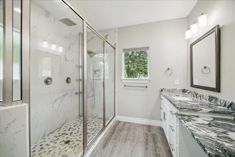 a bathroom with a granite countertop sink and a mirror