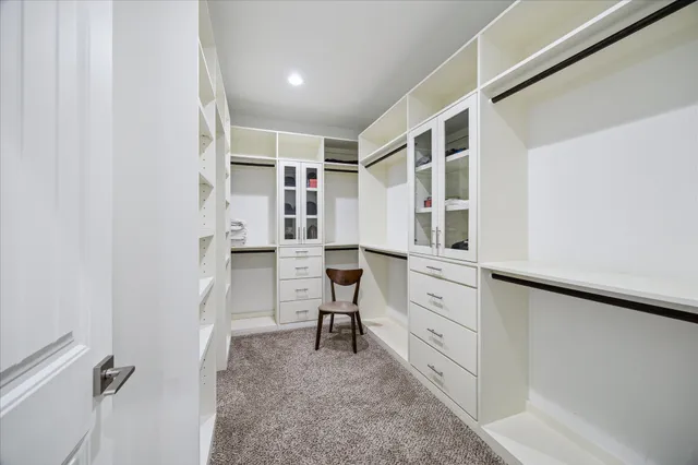 a view of walk in closet with empty racks