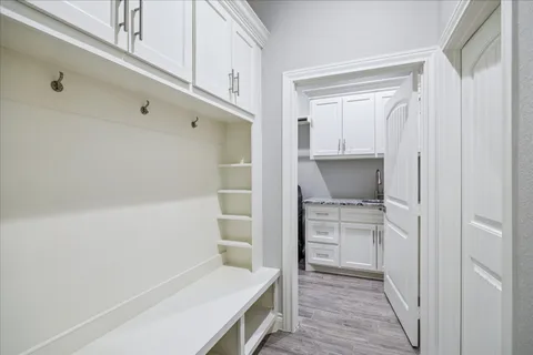 a patio with a table and chairs under an umbrella