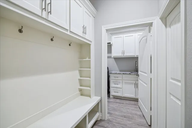 a kitchen with white cabinets and white appliances