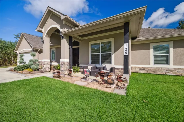 a view of a house with backyard sitting area and garden