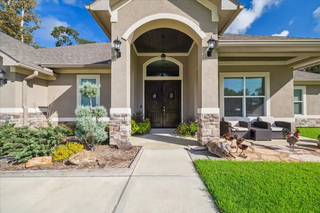 a front view of a house with sitting area