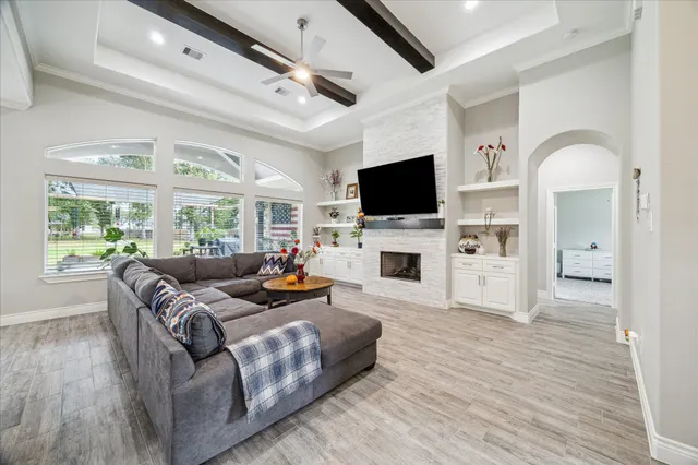 a living room with fireplace furniture and a flat screen tv