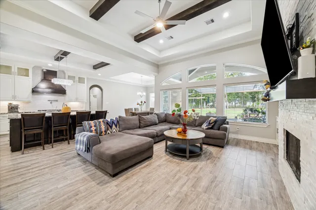 a living room with furniture fireplace and a flat screen tv