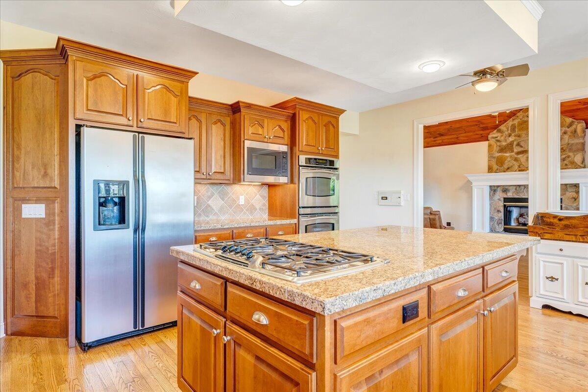 625 Frontier Way Fincastle, VA 24090 - Photo 24 of 105 a kitchen that has a kitchen island wooden cabinets and refrigerator