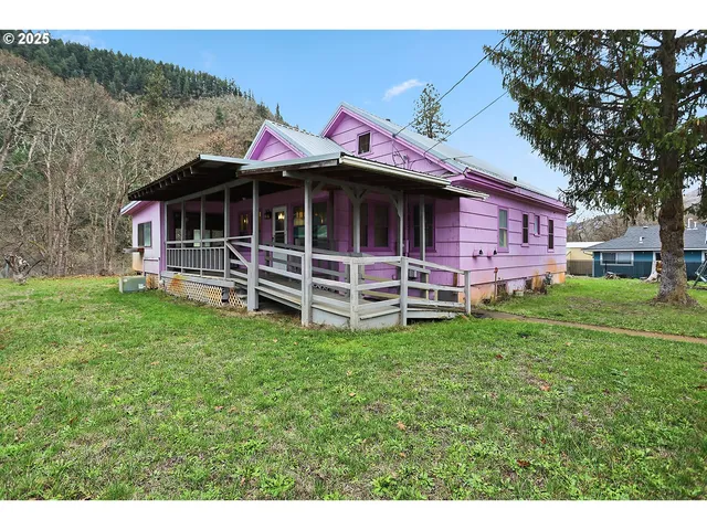 a front view of a house with a yard table and chairs