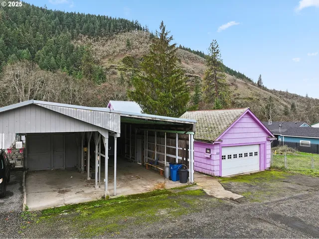 a view of a house with a yard balcony and tree